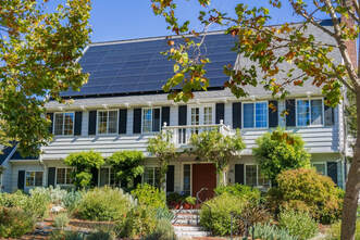 Solar panels on the front of a beautiful white 2-story colonial home in the heart of East Sacramento.